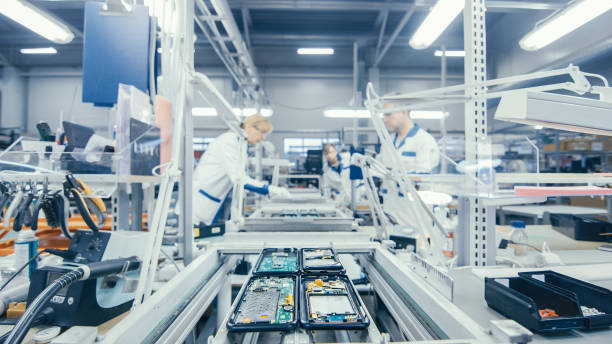 istock Shot of an Electronics Factory Workers Assembling Circuit Boards by Hand While it Stands on the Assembly Line. High Tech Factory Facility. 1145276210