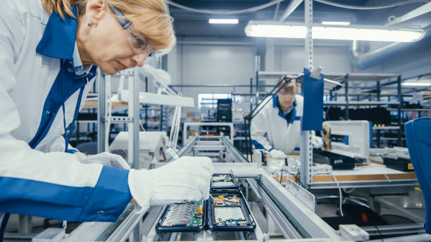 istock Shot of an Electronics Factory Workers Assembling Circuit Boards by Hand While it Stands on the Assembly Line. High Tech Factory Facility. 1145276223