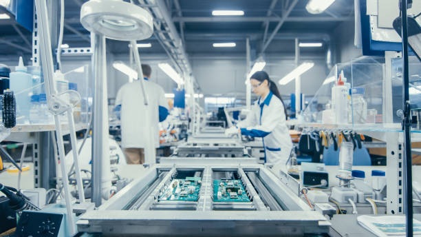 istock Shot of an Electronics Factory Workers Assembling Circuit Boards by Hand While it Stands on the Assembly Line. High Tech Factory Facility. 1145276224
