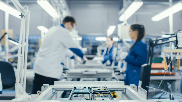 istock Shot of an Electronics Factory Workers Assembling Circuit Boards by Hand While it Stands on the Assembly Line. High Tech Factory Facility. 1145276260