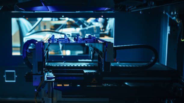 istock Automated Robotic Industrial Equipment is Testing Electronic Printed Circuit Board with Blue Neon Light and Laser Technology After Assembly. 1145276280