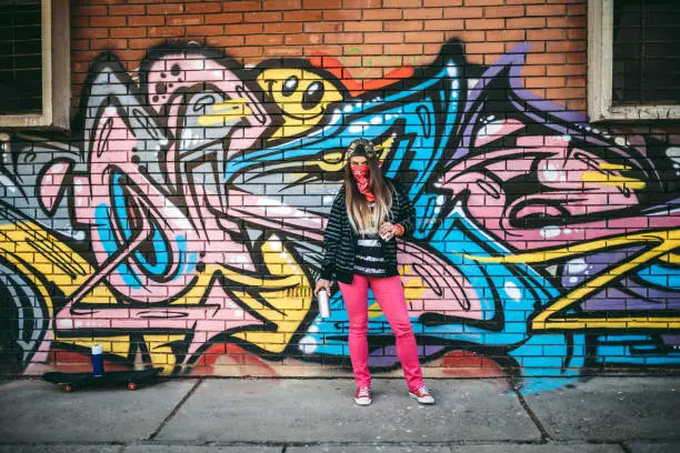 Photo of Graffiti artist with spray paint
