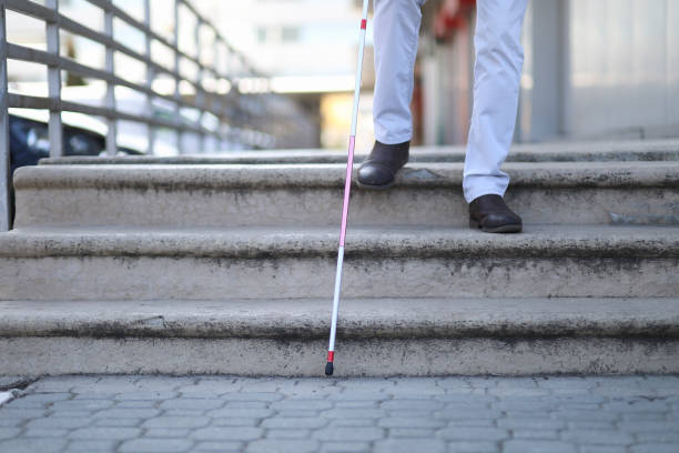 istock Blind and bearded man with a walking stick on the street 1145282042