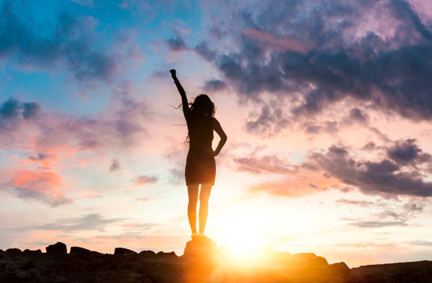 Woman Silhouette at sunset on hill