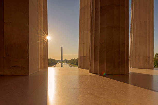 istock Sunrise through Lincoln Memorial Architectural Column with Washington Monument in Background 1145285044