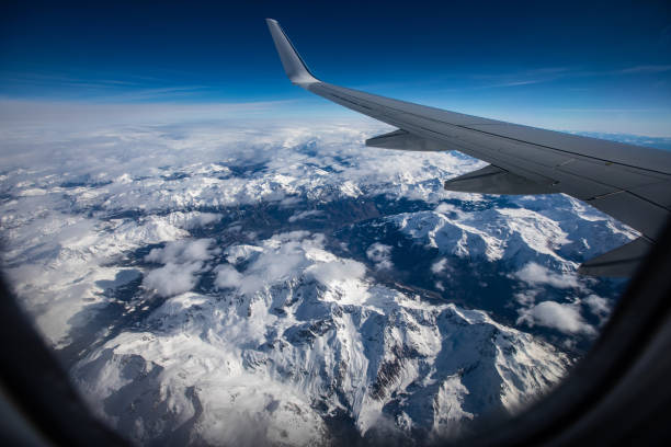 pausenpunkt aus dem fenster des kommerziellen flugzeugs - snow winter mountain horizon over land stock-fotos und bilder