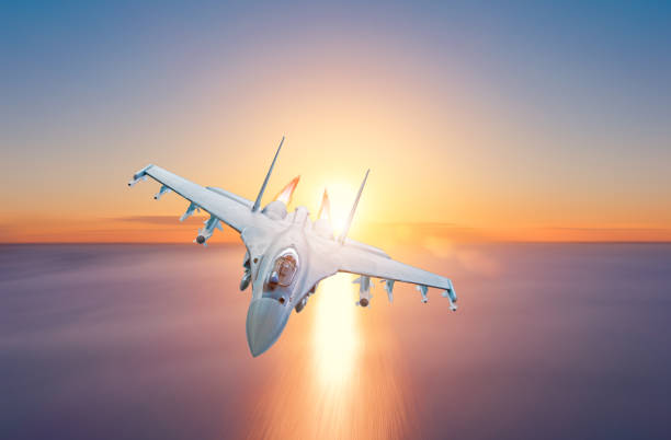 istock Afterburner fighter jet flies over the sea during sunset. 1145289877