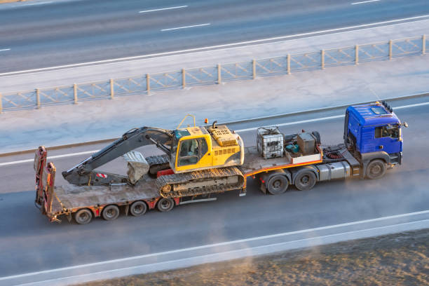 large truck transporting a sizable excavator on its flatbed