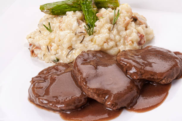 Italian food asparagus risotto with fillet with wood sauce stock photo