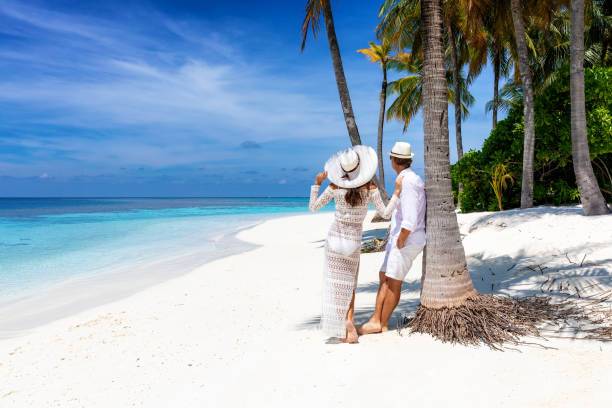 istock Couple enjoys the summer vacation time on a tropical beach 1145297301