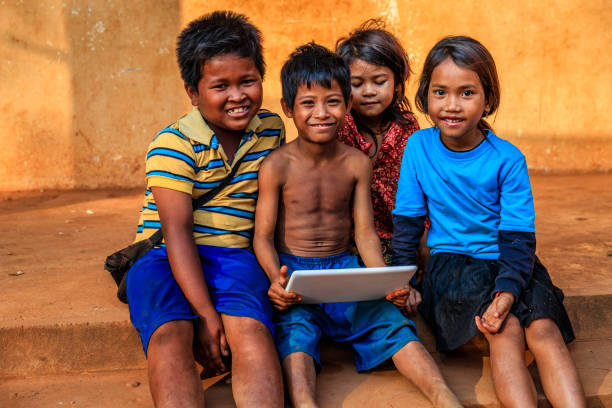 istock Happy Cambodian children using tablet on a schoolyard, Cambodia 1145300774