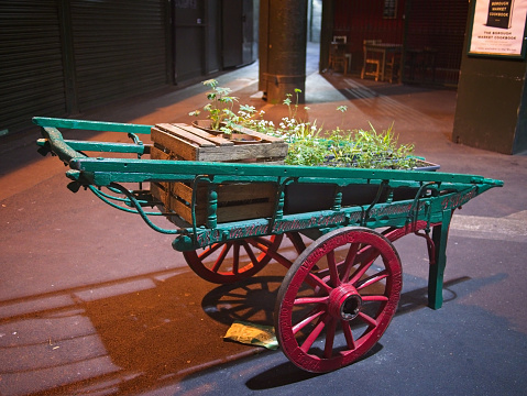 Decorative cart with flowers at the Borough Market in the evening.