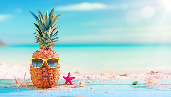 Pineapple With Sunglasses On Seashore