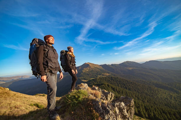 istock The happy couple standing on the sunny mountain 1145301788