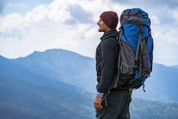 istock The male with a camping backpack standing on the mountain 1145301794