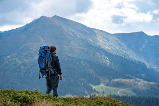 istock The man with a camping backpack standing on the mountain 1145301862