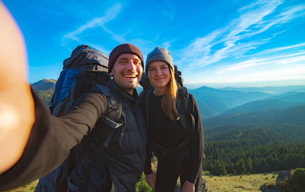 istock The happy couple taking a selfie on the mountain background 1145301970