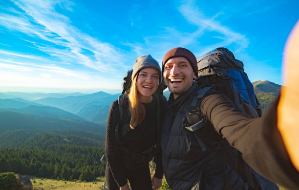 istock The beautiful couple taking a selfie on the mountain background 1145302238
