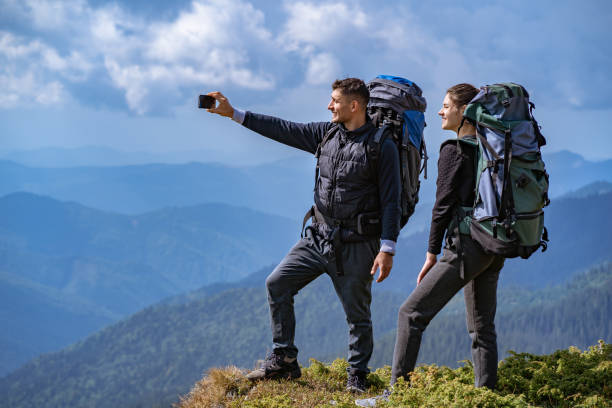 istock The couple with backpacks taking a selfie on the cliff 1145302393