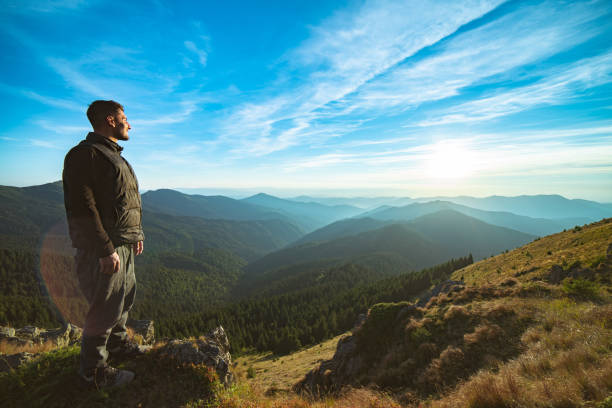istock The happy man standing on the beautiful mountain landscape background 1145302409