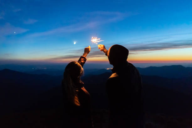 istock The man and a woman hold firework sticks. evening night time 1145303314