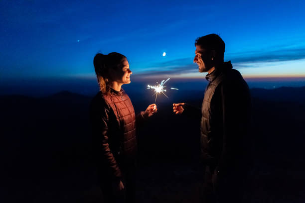 istock The happy couple holding firework sticks on the mountain background 1145303414