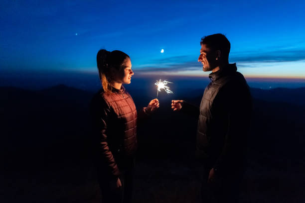 istock The happy couple holding firework sticks on the mountain background 1145303543