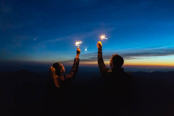 istock The man and a woman hold firework sticks. evening night time 1145303594
