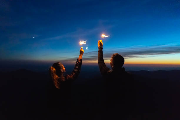 istock The man and a woman holding firework sticks. evening night time 1145303642