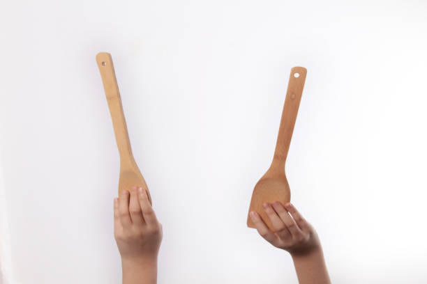 istock Wooden spatula in hand , isolated on white background 1145306001