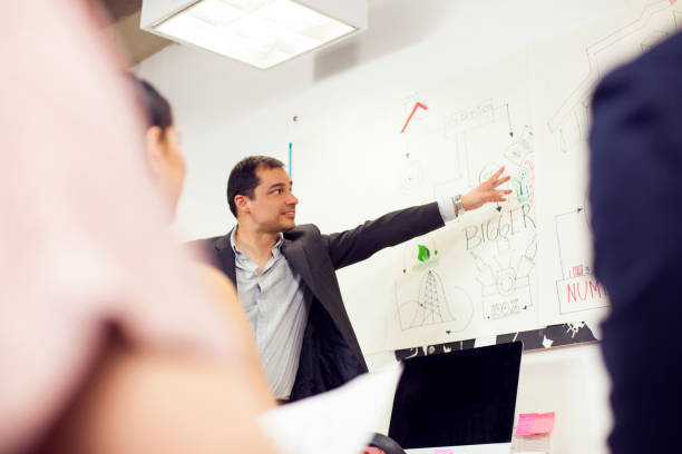 istock Boss making an explanation to all workers in the office. 1145315460