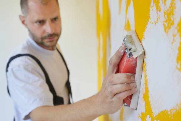 istock Sanding wall with a sanding block after skim coating. Preparation before painting. Renovation house concept. 1145316591
