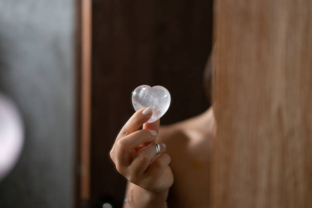 istock Woman holds rose quartz heart crystal 1145317074