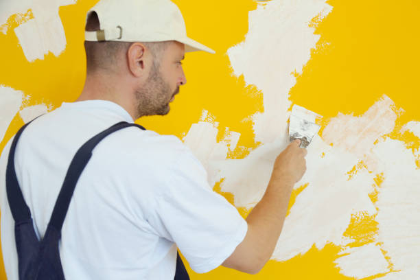 istock Man plastering wall with putty-knife, close up image. Fixing wall surface and preparation for painting. 1145317346
