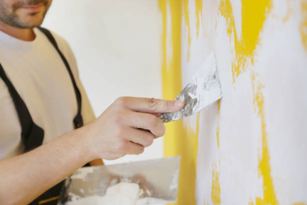 istock Man plastering wall with putty-knife, close up image. Fixing wall surface and preparation for painting. 1145317396