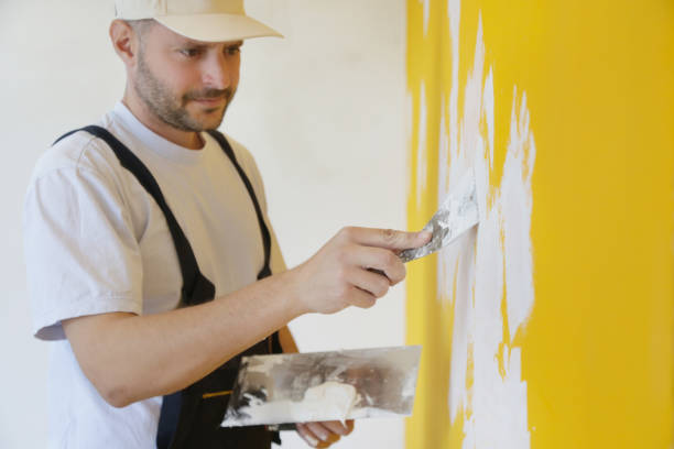 istock Man plastering wall with putty-knife, close up image. Fixing wall surface and preparation for painting. 1145319126