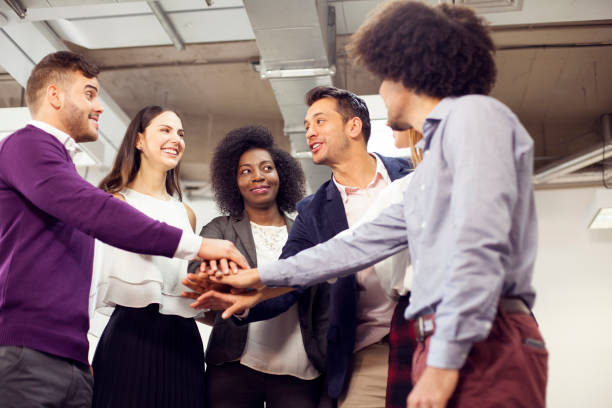 istock Multiethnic work team put their hands together as a sign of group union 1145319144