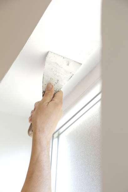 istock Man plastering wall with putty-knife, close up image. Fixing wall surface and preparation for painting. 1145319227