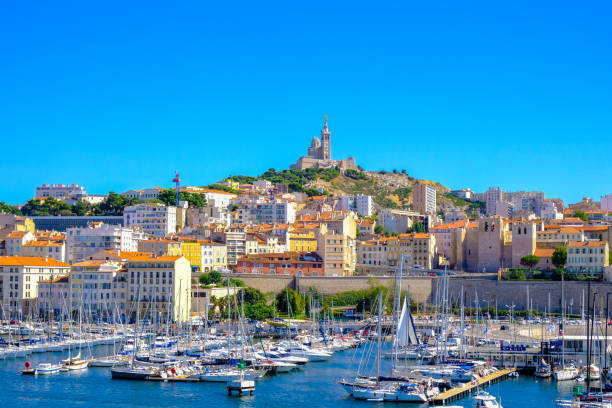 terraplén de marsella con yates y barcos en el puerto viejo y notre dame de la garde. vieux-port de marseille. - notre fotografías e imágenes de stock