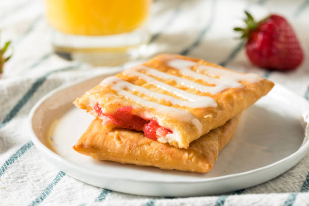 Sweet Breakfast Strawberry Toaster Pastry Sweet Breakfast Strawberry Toaster Pastry with Frosting strudel stock pictures, royalty-free photos & images