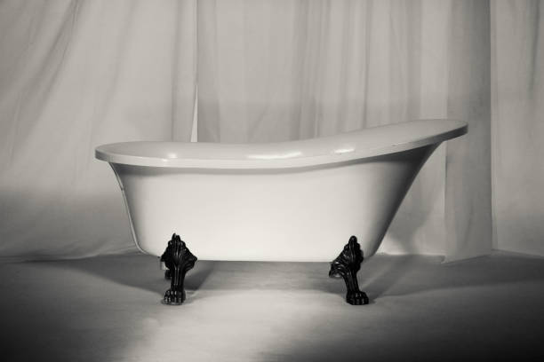 istock ceramic bath on golden legs. Vintage style 1145330105