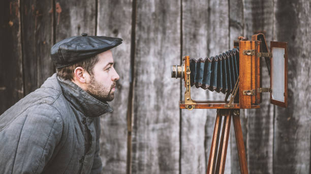 istock Concept - selfie. Selfie of old fashioned man on large format camera 1145330245