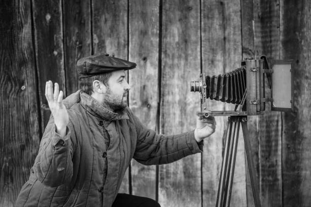 istock Concept - selfie. Selfie of old fashioned man on large format camera 1145330246