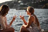 Friends drinking wine by the sea