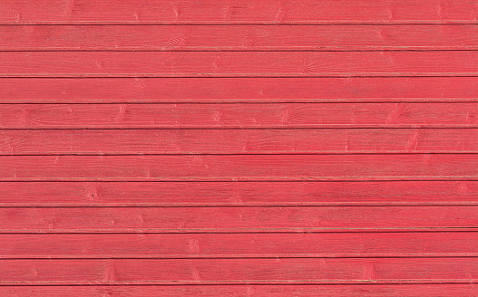 Wooden planks painted into red color background.