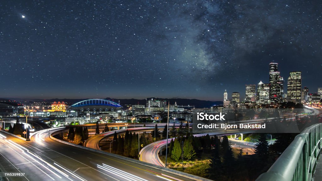 Milky Way Night Sky over City Skyline Seattle New Skyline with Stars and Galaxy Above. Seattle Stock Photo