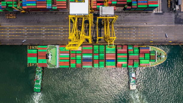 istock Container ship loading and unloading in deep sea port, Aerial top view of logistic import export transportation business by container ship in open sea. 1145365416