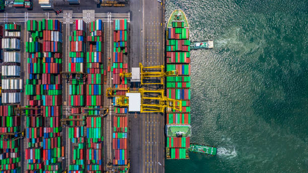 istock Container ship loading and unloading in deep sea port, Aerial top view of logistic import export transportation business by container ship in open sea. 1145365439