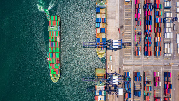 istock Container ship loading and unloading in deep sea port, Aerial top view of logistic import export transportation business by container ship in open sea. 1145366829