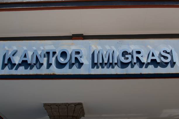 Close up of the Immigration Office (Kantor Imigrasi) Sign in Denpasar, Bali Close up picture of the text Kantor Imigrasi (Immigration Office) of the Immigration Office in Denpasar, Bali, Indonesia kantor stock pictures, royalty-free photos & images